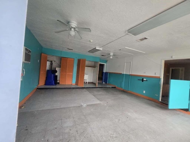830 Stonyridge St, Channelview, TX 77530 - garage featuring ceiling fan, a wall unit AC, and baseboards