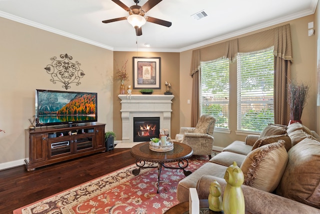 24119 Blue Crest Dr, Porter, TX 77365 - living area with dark wood-type flooring, ornamental molding, a ceiling fan, a glass covered fireplace, and healthy amount of natural light