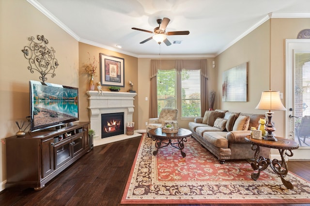 24119 Blue Crest Dr, Porter, TX 77365 - living area featuring dark wood finished floors, crown molding, ceiling fan, a lit fireplace, and baseboards
