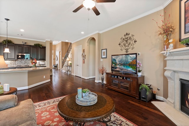 24119 Blue Crest Dr, Porter, TX 77365 - living area with dark wood-style floors, a ceiling fan, arched walkways, ornamental molding, and recessed lighting
