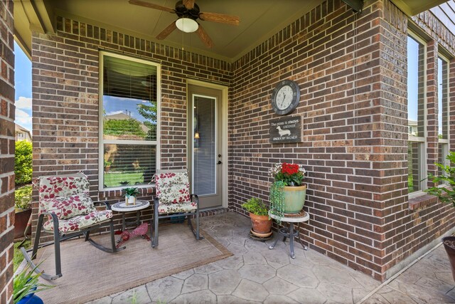 24119 Blue Crest Dr, Porter, TX 77365 - view of exterior entry featuring a ceiling fan, brick siding, and a patio area
