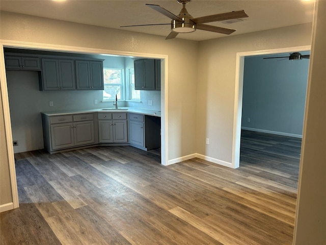 6698 Verde St, Groves, TX 77619 - kitchen featuring a ceiling fan, a sink, wood finished floors, and light countertops