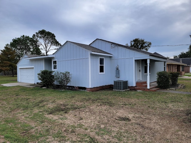 6698 Verde St, Groves, TX 77619 - view of front of home featuring a front yard, board and batten siding, a garage, and central AC