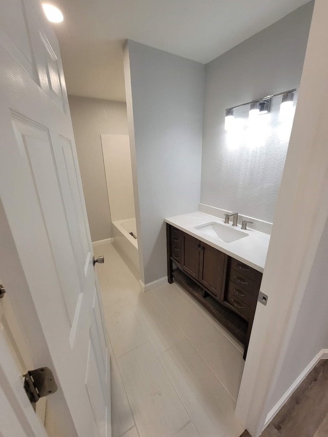 6698 Verde St, Groves, TX 77619 - full bathroom with vanity and baseboards