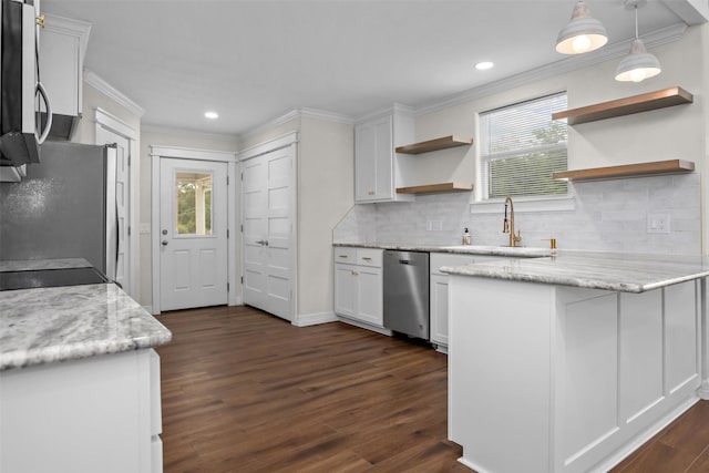 809 E Bowie Ave, Crockett, TX 75835 - kitchen with stainless steel appliances, open shelves, white cabinetry, ornamental molding, and dark wood-style floors