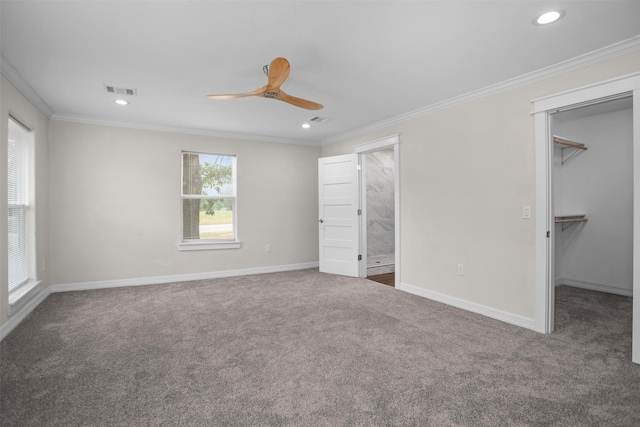 809 E Bowie Ave, Crockett, TX 75835 - unfurnished bedroom featuring carpet flooring, crown molding, a walk in closet, recessed lighting, and baseboards