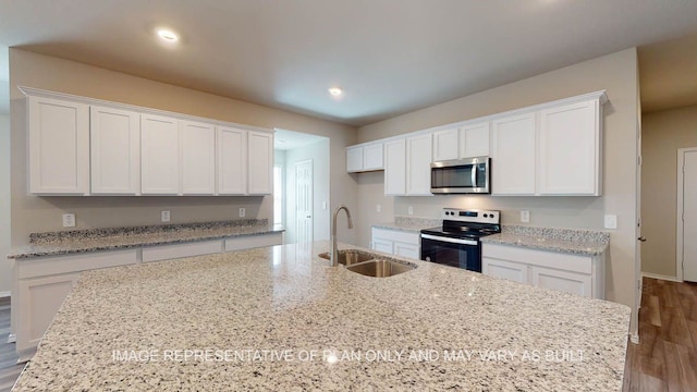 12512 Tarres Ct, Lorena, TX 76655 - kitchen featuring electric range, stainless steel microwave, a sink, white cabinetry, and recessed lighting