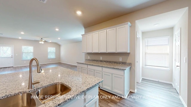 12512 Tarres Ct, Lorena, TX 76655 - kitchen featuring a sink, light wood-style flooring, ceiling fan, white cabinetry, and recessed lighting