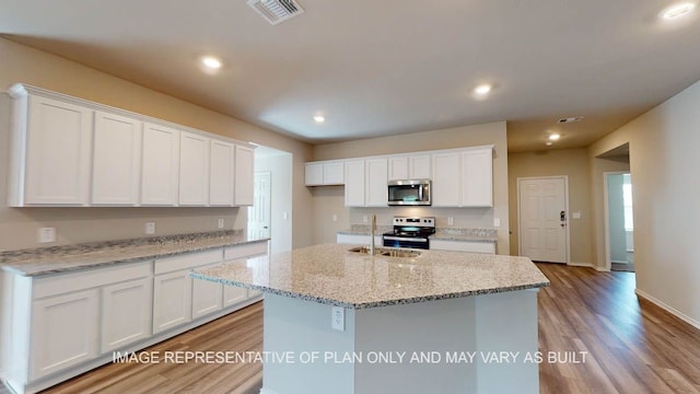 12512 Tarres Ct, Lorena, TX 76655 - kitchen with appliances with stainless steel finishes, a sink, light wood finished floors, white cabinetry, and recessed lighting