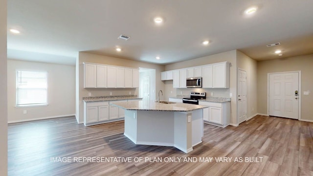 12512 Tarres Ct, Lorena, TX 76655 - kitchen with appliances with stainless steel finishes, light wood finished floors, baseboards, white cabinets, and recessed lighting