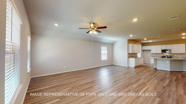 12512 Tarres Ct, Lorena, TX 76655 - unfurnished living room featuring light wood finished floors, a ceiling fan, baseboards, and recessed lighting