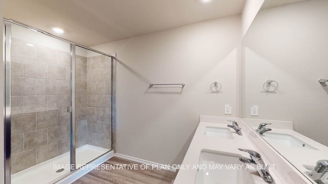 12512 Tarres Ct, Lorena, TX 76655 - full bathroom with a shower stall, wood finished floors, double vanity, recessed lighting, and baseboards