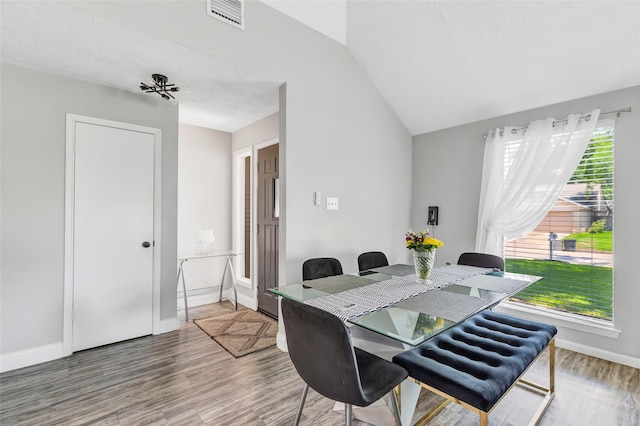 19011 Sandia Pines Dr, Humble, TX 77346 - dining room featuring wood finished floors, baseboards, and vaulted ceiling