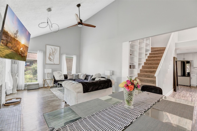 19011 Sandia Pines Dr, Humble, TX 77346 - dining area featuring light wood-type flooring, high vaulted ceiling, a ceiling fan, and stairway