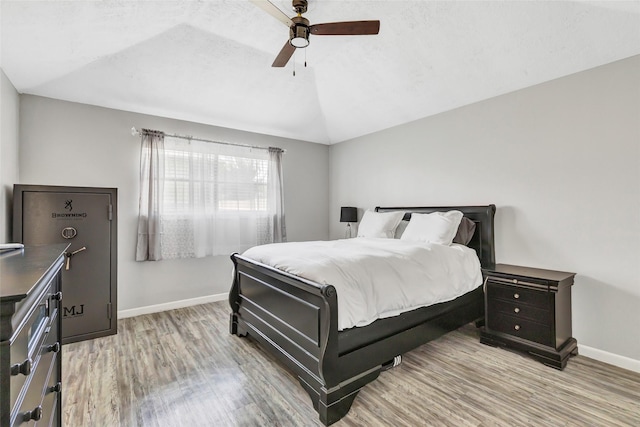 19011 Sandia Pines Dr, Humble, TX 77346 - bedroom featuring baseboards, light wood-style floors, vaulted ceiling, and a ceiling fan