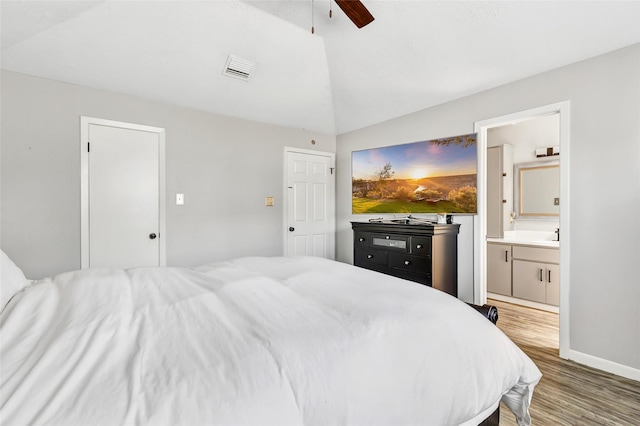 19011 Sandia Pines Dr, Humble, TX 77346 - bedroom with light wood-style flooring, lofted ceiling, ensuite bathroom, ceiling fan, and baseboards