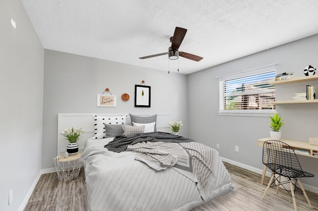 19011 Sandia Pines Dr, Humble, TX 77346 - bedroom with wood finished floors, baseboards, a textured ceiling, and ceiling fan