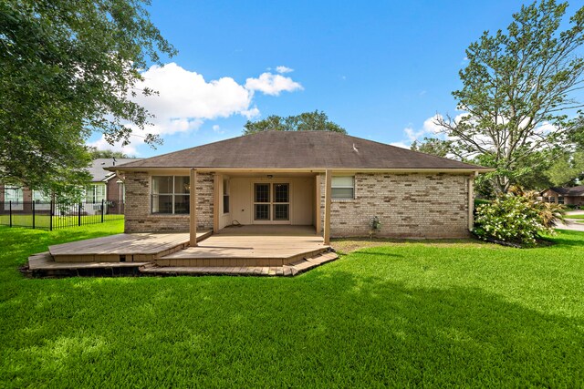 907 S Peach Hollow Ct, Pearland, TX 77584 - back of house featuring brick siding, a wooden deck, and a shingled roof