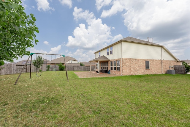 20511 Noble Ranch Ct, Richmond, TX 77407 - back of property featuring brick siding, a patio area, central air condition unit, and a playground