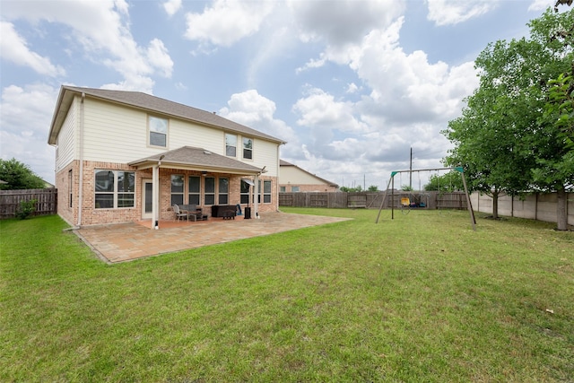 20511 Noble Ranch Ct, Richmond, TX 77407 - rear view of house featuring brick siding, a patio, and a playground