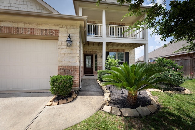 20511 Noble Ranch Ct, Richmond, TX 77407 - entrance to property featuring a balcony, an attached garage, driveway, and stone siding