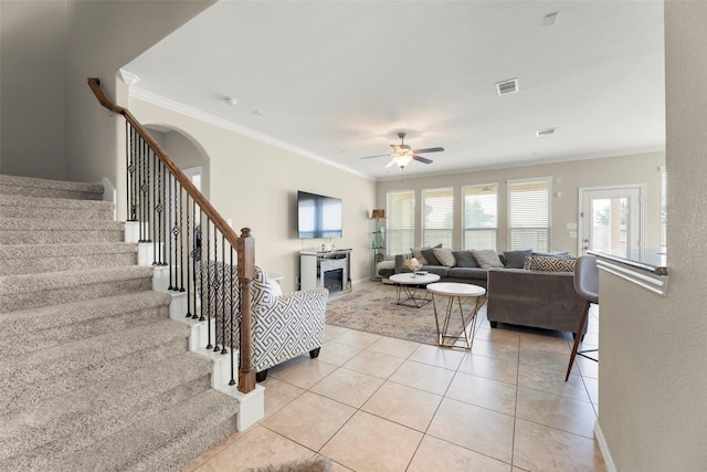20511 Noble Ranch Ct, Richmond, TX 77407 - living area with ornamental molding, ceiling fan, stairs, healthy amount of natural light, and light tile patterned flooring
