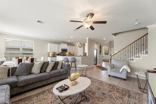 20511 Noble Ranch Ct, Richmond, TX 77407 - living area with light tile patterned floors, a ceiling fan, arched walkways, baseboards, and crown molding