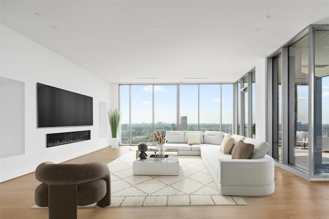 1711 Allen Pkwy Unit 3401, Houston, TX 77019 - living area featuring floor to ceiling windows, wood finished floors, a glass covered fireplace, and baseboards