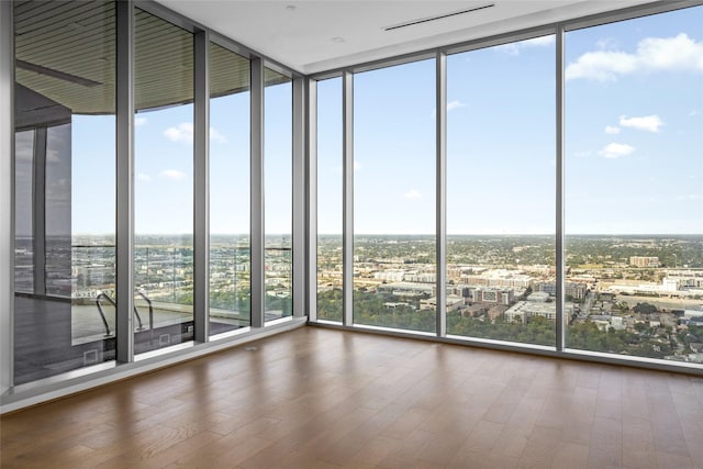 1711 Allen Pkwy Unit 3401, Houston, TX 77019 - empty room featuring a wall of windows, wood finished floors, and a city view