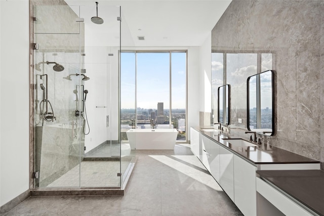 1711 Allen Pkwy Unit 3401, Houston, TX 77019 - full bathroom with a stall shower, a soaking tub, double vanity, and a wall of windows