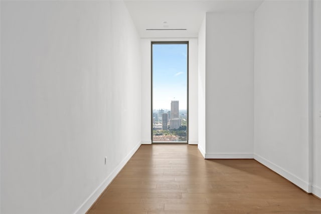 1711 Allen Pkwy Unit 3401, Houston, TX 77019 - spare room with a wall of windows, wood finished floors, and baseboards