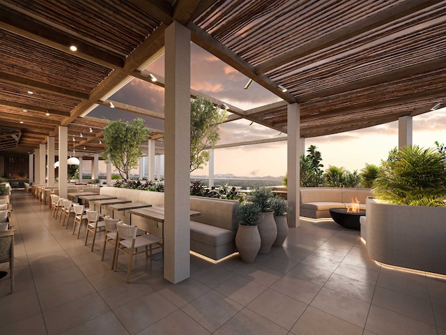 1711 Allen Pkwy Unit 3401, Houston, TX 77019 - patio terrace at dusk featuring an outdoor fire pit, a patio area, and exterior bar
