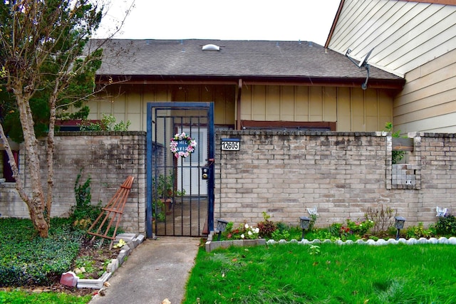 12605 Wellington Park Dr Unit 17, Houston, TX 77072 - doorway to property featuring a gate, brick siding, and a shingled roof