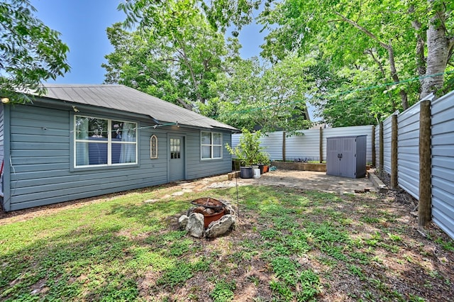 213 N Austin St, Brenham, TX 77833 - fenced backyard featuring a fire pit and a patio