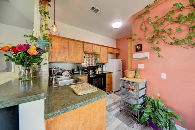 213 N Austin St, Brenham, TX 77833 - kitchen featuring electric range, a sink, freestanding refrigerator, dark countertops, and decorative backsplash