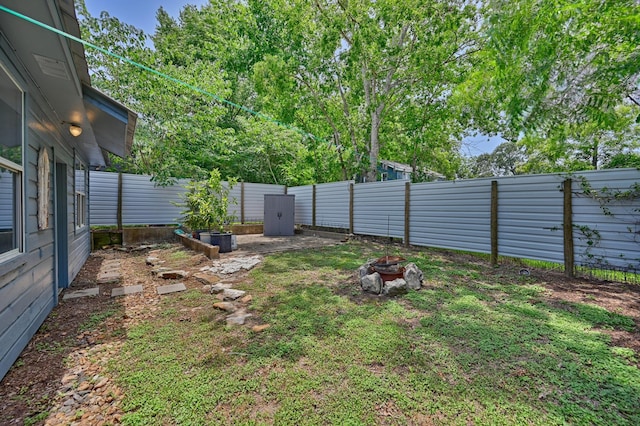 213 N Austin St, Brenham, TX 77833 - fenced backyard with an outdoor fire pit