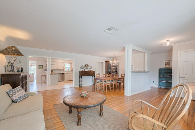 10318 Raritan Dr, Houston, TX 77043 - living area with a chandelier, ornamental molding, light wood finished floors, and baseboards