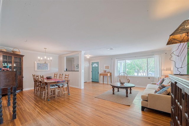 10318 Raritan Dr, Houston, TX 77043 - living room with a chandelier, light wood-type flooring, baseboards, and ornamental molding