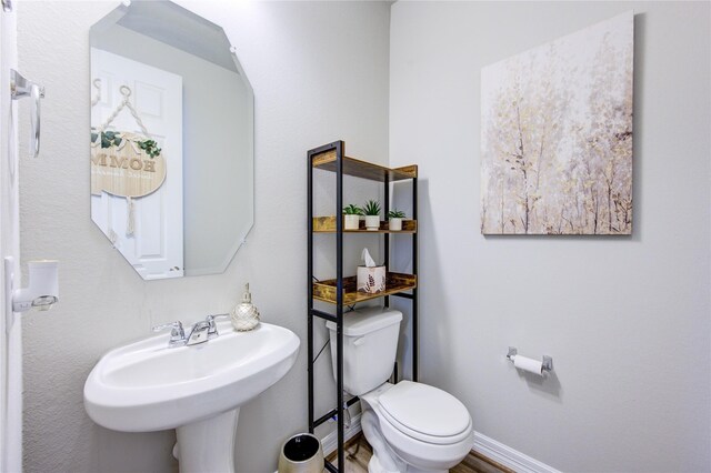 2432 Solaris Bend Dr, Katy, TX 77493 - half bathroom with toilet, a sink, and baseboards