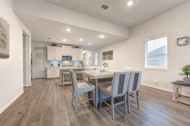 2432 Solaris Bend Dr, Katy, TX 77493 - dining space with light wood finished floors, baseboards, healthy amount of natural light, and recessed lighting