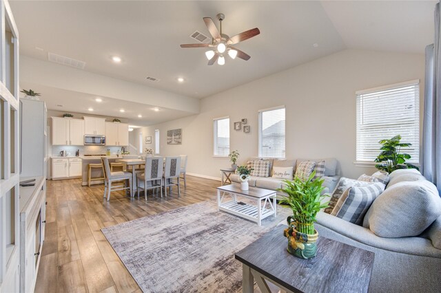 2432 Solaris Bend Dr, Katy, TX 77493 - living room featuring light wood-type flooring, ceiling fan, lofted ceiling, and recessed lighting