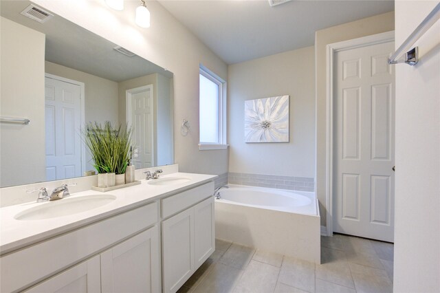 2432 Solaris Bend Dr, Katy, TX 77493 - bathroom with double vanity, a garden tub, and tile patterned floors