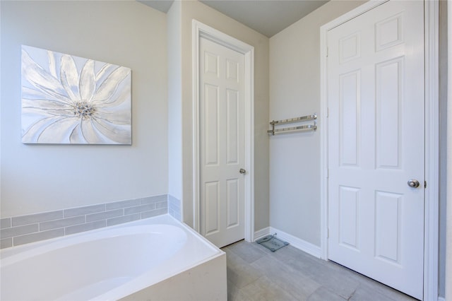 2432 Solaris Bend Dr, Katy, TX 77493 - bathroom featuring a garden tub and tile patterned floors