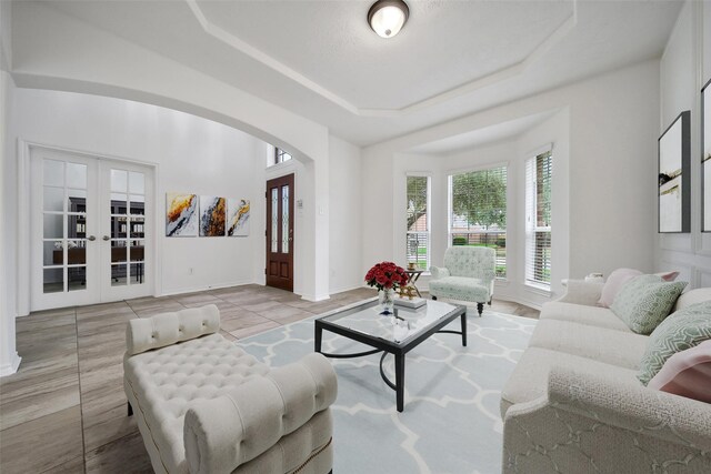 714 Stubbs Bend Dr, Rosenberg, TX 77469 - living room with french doors, arched walkways, a raised ceiling, and baseboards