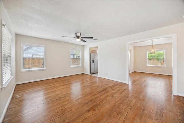 4502 Hain St, Houston, TX 77009 - spare room featuring wood finished floors, plenty of natural light, ceiling fan, and baseboards