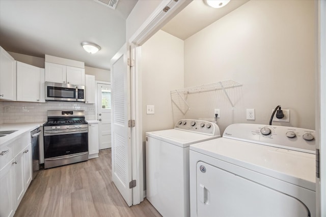 4502 Hain St, Houston, TX 77009 - laundry room featuring washer and dryer and light wood-type flooring
