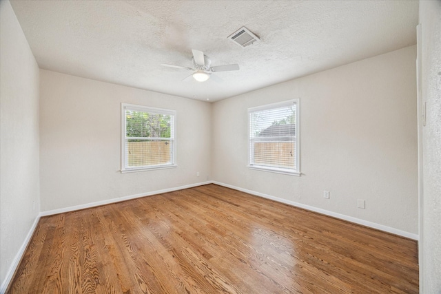 4502 Hain St, Houston, TX 77009 - empty room featuring ceiling fan, wood finished floors, baseboards, and a textured ceiling
