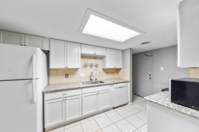 12633 Memorial Dr Unit 170, Houston, TX 77024 - kitchen with white appliances, a sink, backsplash, light tile patterned flooring, and light stone counters