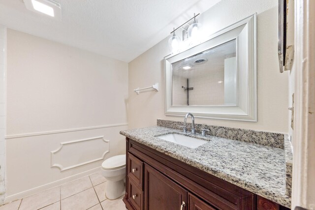 12633 Memorial Dr Unit 170, Houston, TX 77024 - bathroom with toilet, vanity, tile patterned flooring, and tiled shower