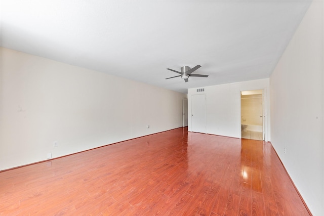 12633 Memorial Dr Unit 170, Houston, TX 77024 - spare room with wood finished floors, a ceiling fan, and baseboards